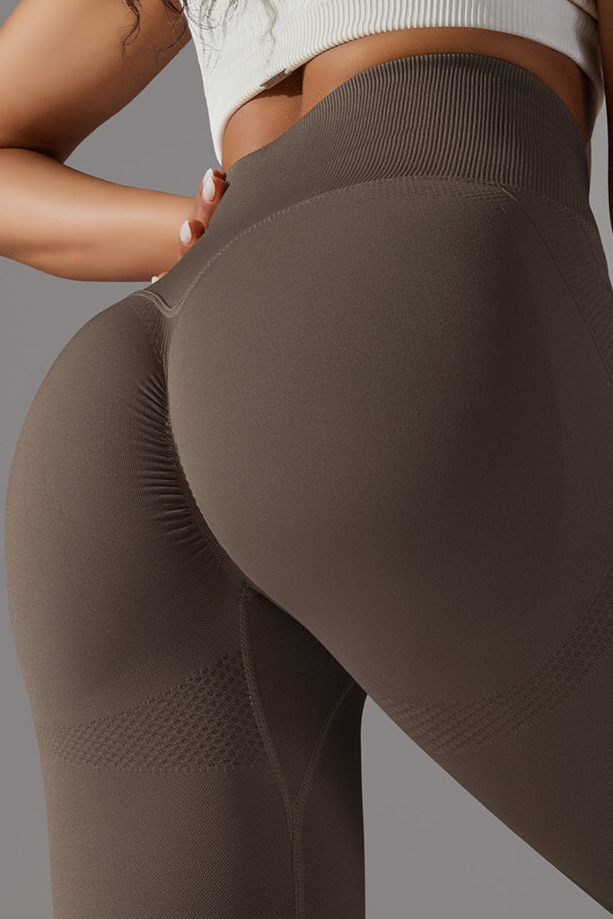 Close-up bagfra af mørkebrune leggings med scrunch-effekt – fremhæver bagdelens form.

